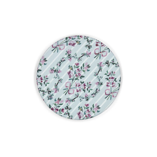Round pocket mirror featuring a pattern of pink flowers and red bows on a pastel blue background.